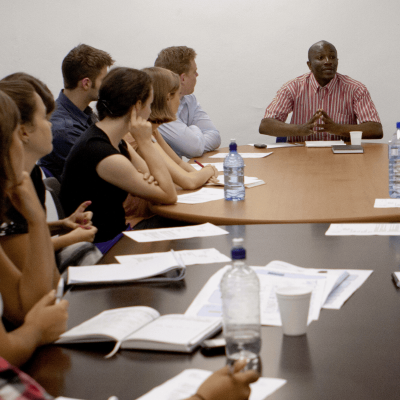 Teen participants gather for a meeting on a human rights project